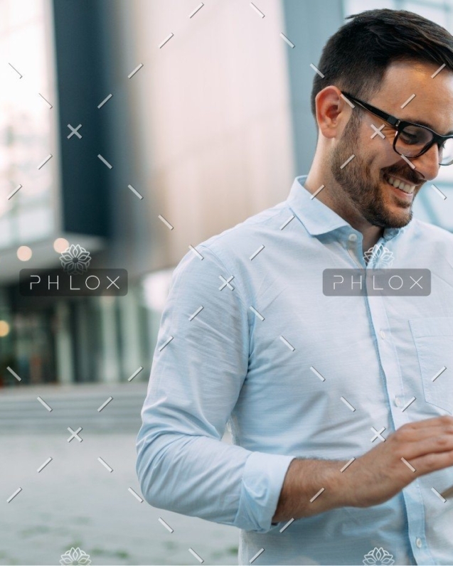 demo-attachment-448-portrait-of-businessman-in-glasses-holding-tablet-AWVHCJU